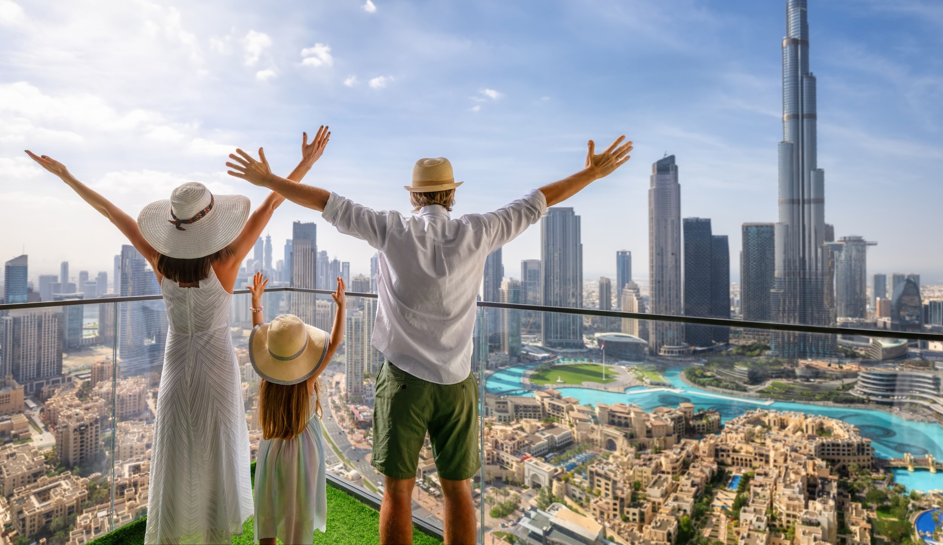 A family on vacation enjoys the view over the skyline of Dubai